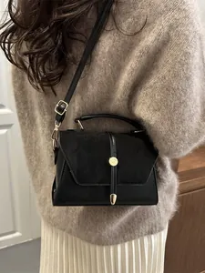 Elegant black crossbody square bag with gold buckle and adjustable strap for women