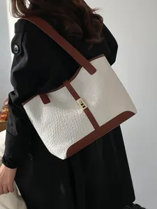 Minimalist large tote bag with white woven leather texture and brown strap on model