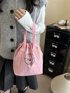 Pink drawstring nylon insulated lunch bag with fashion squirrel logo and top handles
