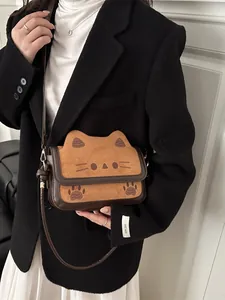 Cute brown cat-shaped crossbody bag featuring suede texture and adjustable shoulder strap