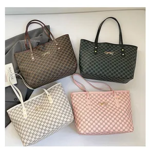 Flat lay of large tote bags in four colors with bow metal buckle and monogram patterns