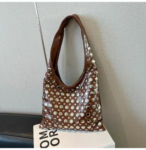 Detailed view of polished dark brown PU leather shoulder bag with silver rivet studs