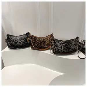 Detailed comparison of three leopard print hobo bags with metallic chain straps