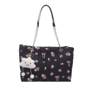 Floral bucket tote bag in black with pink roses, bow patterns and a plush cloud charm