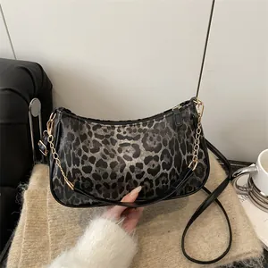 Leopard print half-moon underarm bag with gold chain and black leather shoulder strap