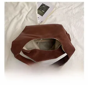 Top view of spacious brown leather tote bag interior with magnetic closure and soft lining
