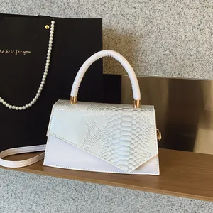 White minimalist square crossbody bag with faux python embossing and smooth finish