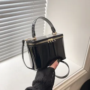 Mini black patent leather box bag with gold zipper and top handle for women