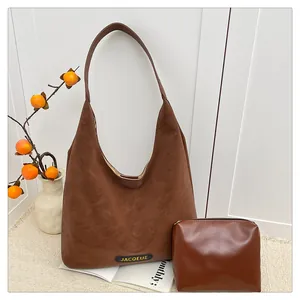 Brown tote bag and matching zipper pouch set shown in a cozy indoor scene setting