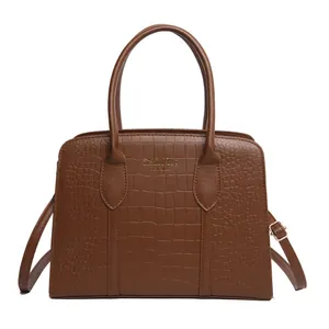 Brown crocodile embossed tote bag with gold lettering and detachable shoulder strap