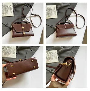 Detailansicht der braunen Vintage-Handtasche mit Metallverschluss und Schutznieten am Boden
