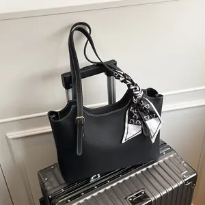 Chic black lychee leather tote bag with heart pattern scarf and gold hardware accents
