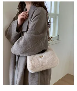 Détail du sac bandoulière en peluche crème avec crochet doré et plaque de marque chic