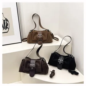 Three retro suede baguette bags in brown and black with vintage buckle detail