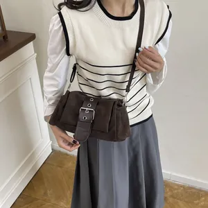 Retro dark brown baguette bag with metal belt buckle detail and crossbody strap