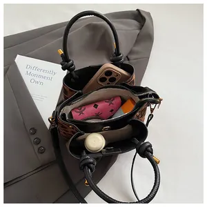 Top view of leopard print bucket bag interior showing spacious compartments and hardware