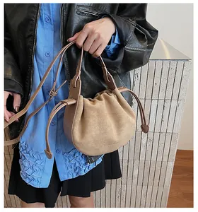 Sac seau en suédine camel porté avec une tenue de mode urbaine élégante et moderne