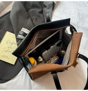 Detail view of large tote bag interior with striped lining and spacious compartments
