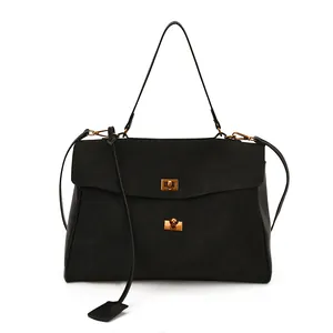 Detail of black matte suede tote bag featuring dual vintage gold twist-lock closures