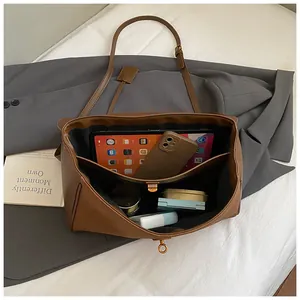 Interior view showing large capacity compartments and organized storage for brown tote bag