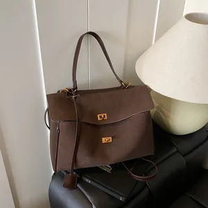 Minimalist dark brown suede tote bag with golden twist locks and versatile straps