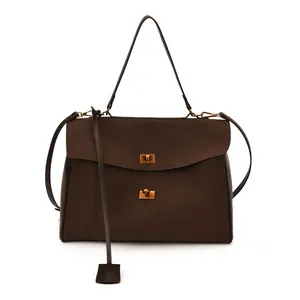 Deep brown suede shoulder bag with golden lock and square charm for daily fashion