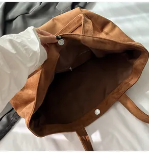 Detail view of large leopard tote interior with suede texture and magnetic closure