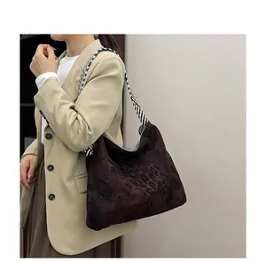 Detail of large leopard print tote bag with thick woven black and white shoulder strap