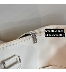 Detailed close-up of smooth silver zipper and durable PU leather on travel tote bag