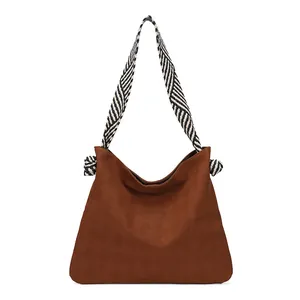 Brown woven tote bag with vintage large capacity and striped strap on white background
