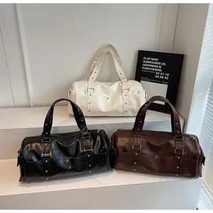 Three premium PU leather duffel bags in ivory, black, and brown with metal rivet details