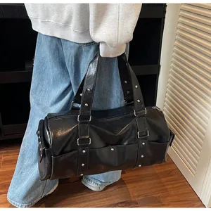 Close-up of black PU leather travel bag featuring silver studs and large side pockets