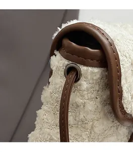 Close-up of premium plush fabric with leather trim and vintage metal hardware