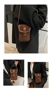 Detail of vintage brown faux suede mini crossbody bag with a toggle horn closure