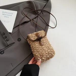 Detail of plush crossbody bag with vintage horn buckle and faux shearling texture