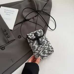 Detail of tweed crossbody bag showing contrast texture and classic toggle closure