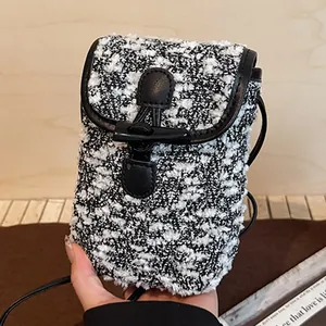 Mini black and white tweed crossbody bag with toggle closure and leather trim