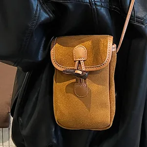 Minimalist brown suede crossbody bag with vintage horn button and leather trim