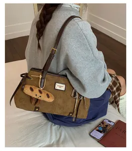 Dettaglio della borsa tote marrone retrò con silhouette Hello Kitty e ciondolo peluche