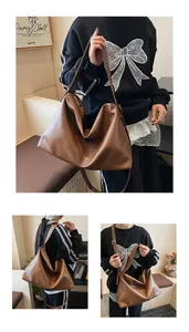Detalle de bolso hobo marrón de gran capacidad con textura de cuero suave y doble correa