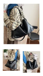 Detalle del bolso tote grande de cuero sintético negro con superficie lisa y correa suave