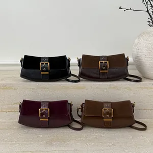 Close-up of four retro color-block underarm bags in black, brown, wine red and tan leather