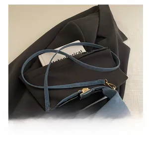 Detailed shot of blue leopard jacquard tote with slim shoulder strap and gold hardware