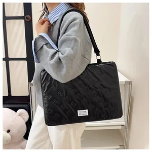 Close-up of black laptop tote bag featuring 3D bow patterns and Fashion brand label