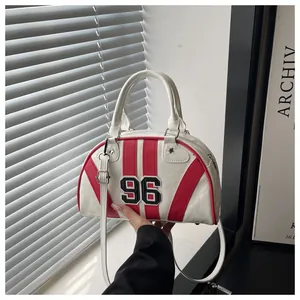 Dettaglio borsa bowling vintage crema con strisce rosse e toppa con numero 96 ricamato