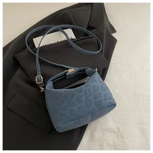 Detailed view of light blue leopard print tote bag on a blazer background