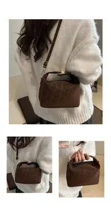 Detail of leopard print tote bag with gold hardware and adjustable strap on a white sweater