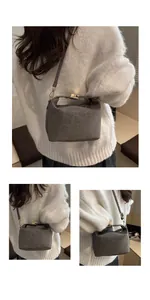 Detail of grey crossbody bag featuring matte animal print and golden metal buckle clasp