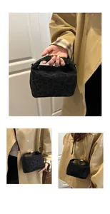 Detail of black leopard print crossbody bag with gold hardware and stylish handle
