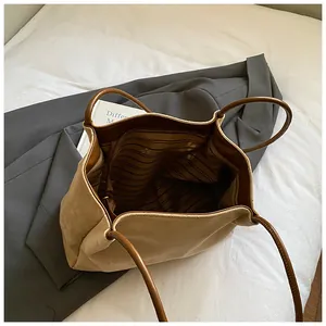Vintage suede tote bag with hollow petal design and spacious interior for daily commute